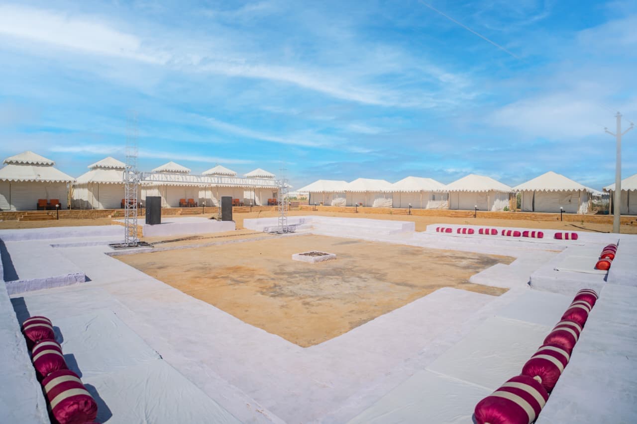 Bonfire and folk-dance arena ringed by Swiss tents at Sam Sand Dunes