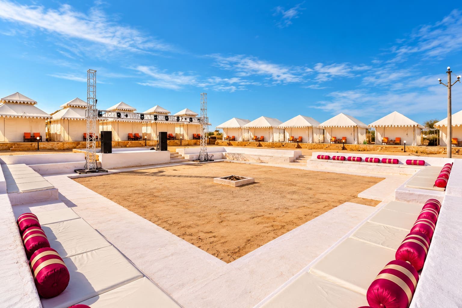Bonfire and folk-dance arena ringed by Swiss tents at Sam Sand Dunes