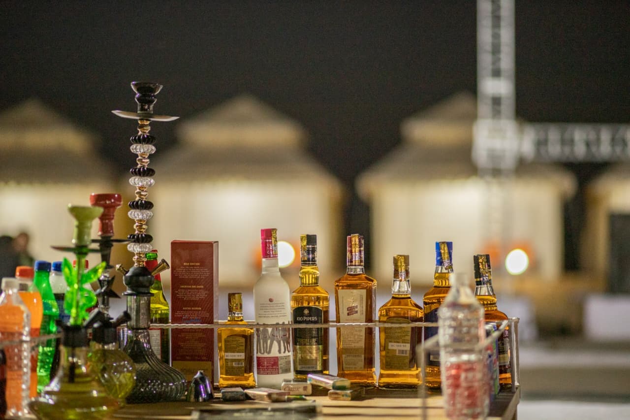 Evening beverage and hookah counter set up in front of the tents at the desert camp